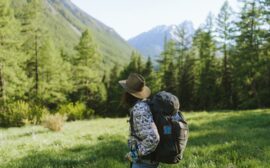 Woman Wearing a Hat Carrying a Backpack