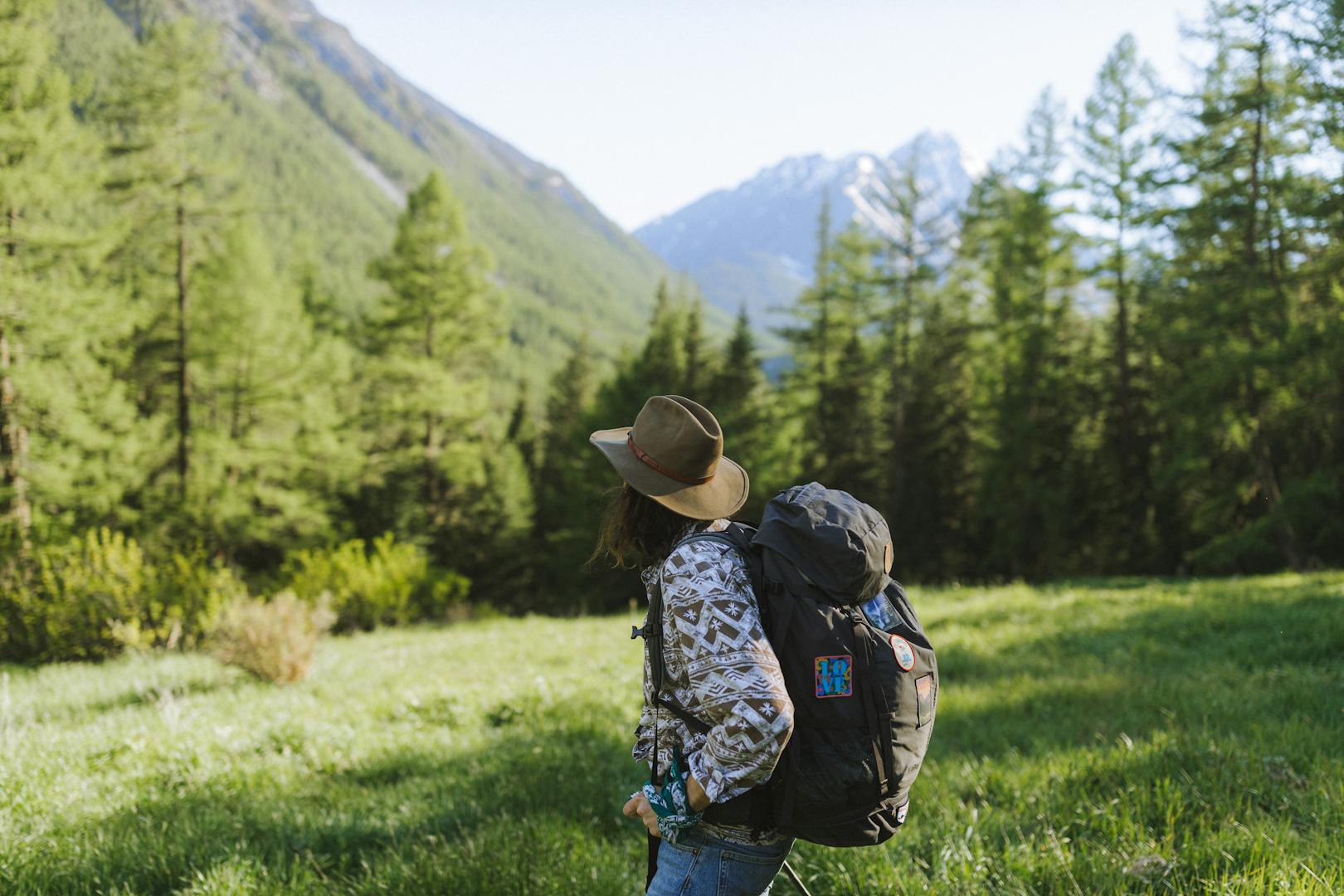 Woman Wearing a Hat Carrying a Backpack